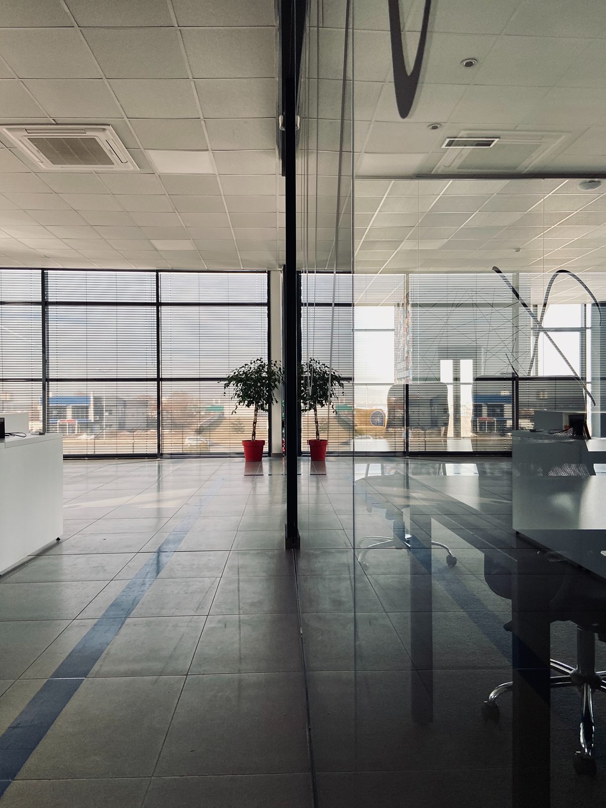office corridor with glass conference rooms on the left