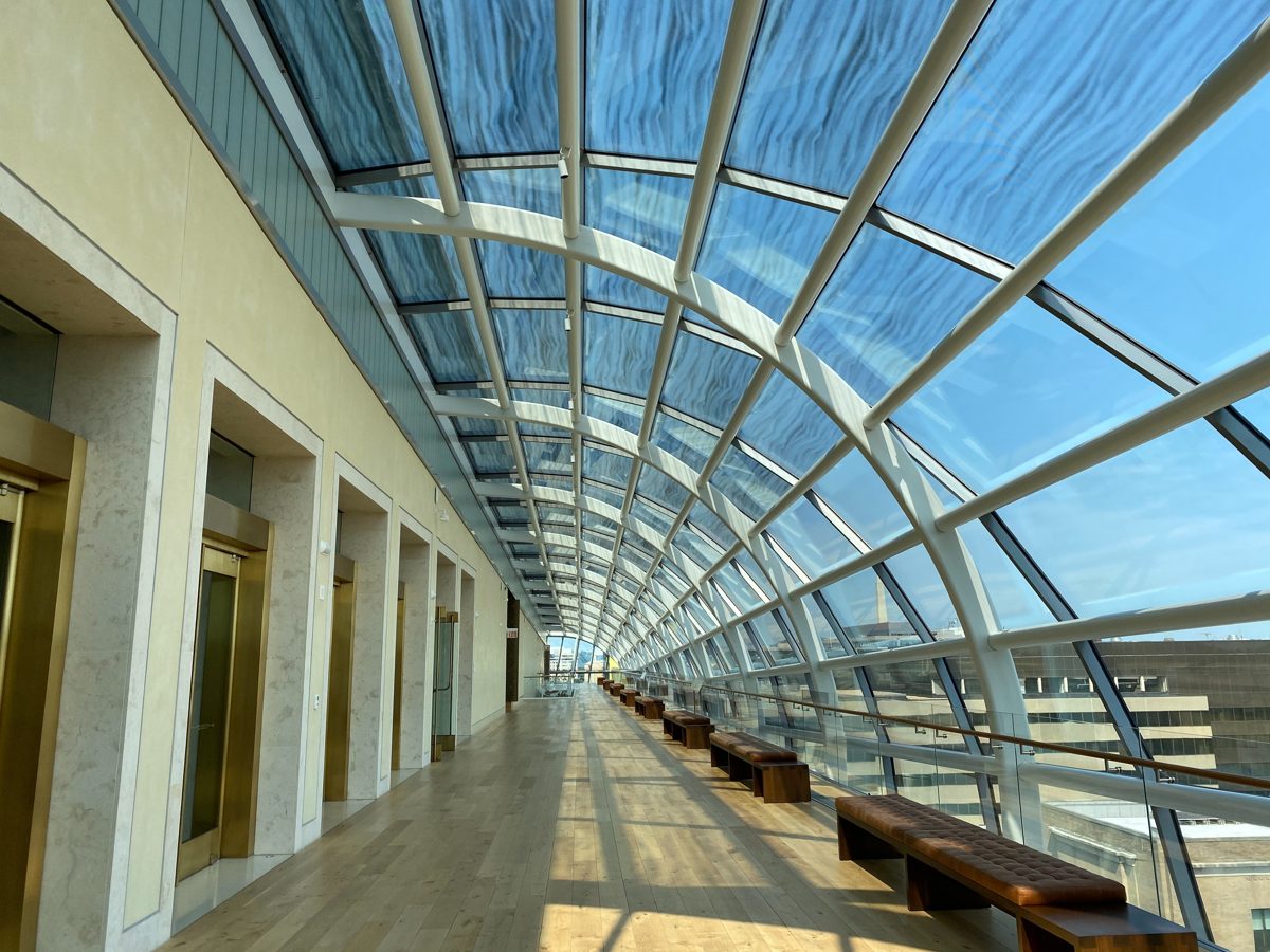 corridor with a curved hypotenuse window with sun light