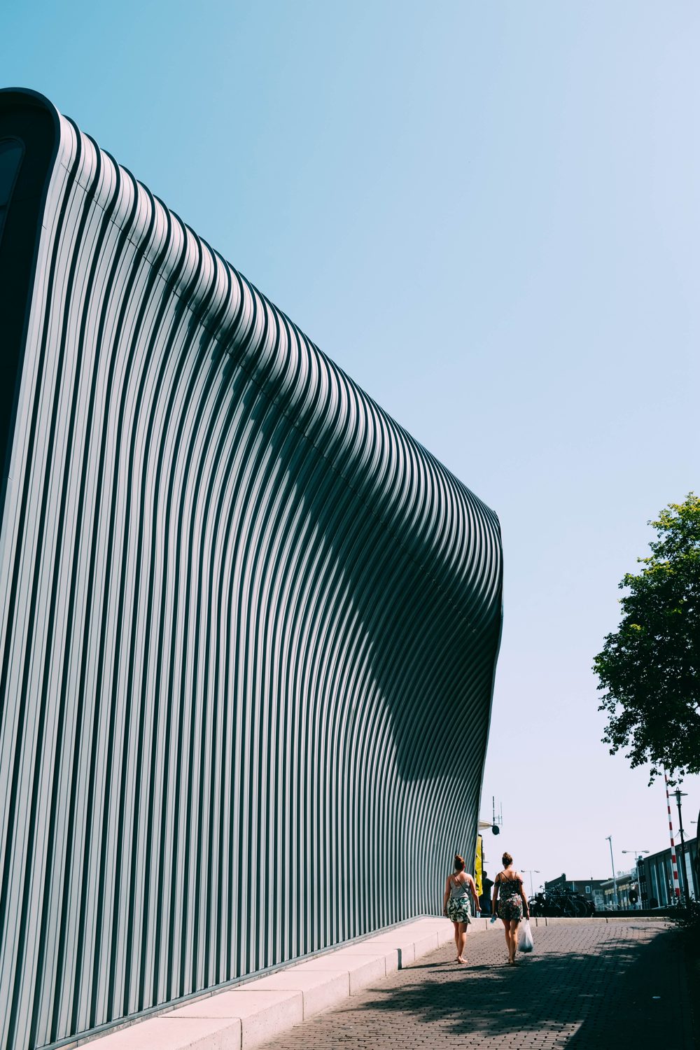 building facade with a curved roof/angle, street view
