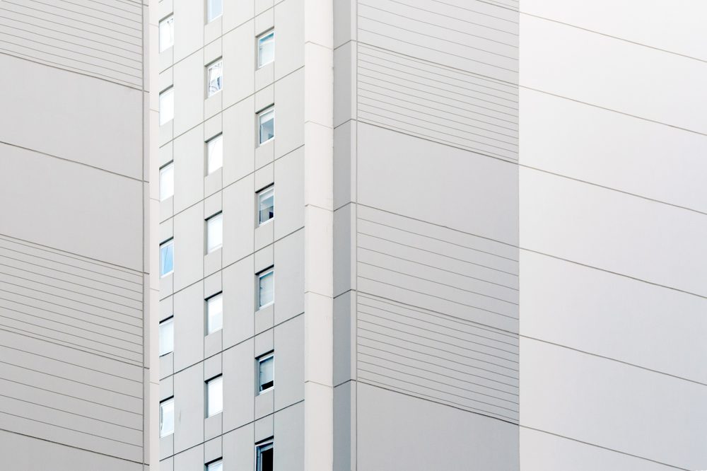 a detailed shot of a white building, the composition flattens the 3 dimension of the building