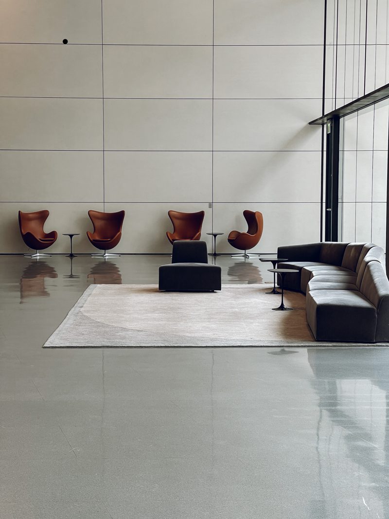 lobby with minimal furnitures and a very high ceiling