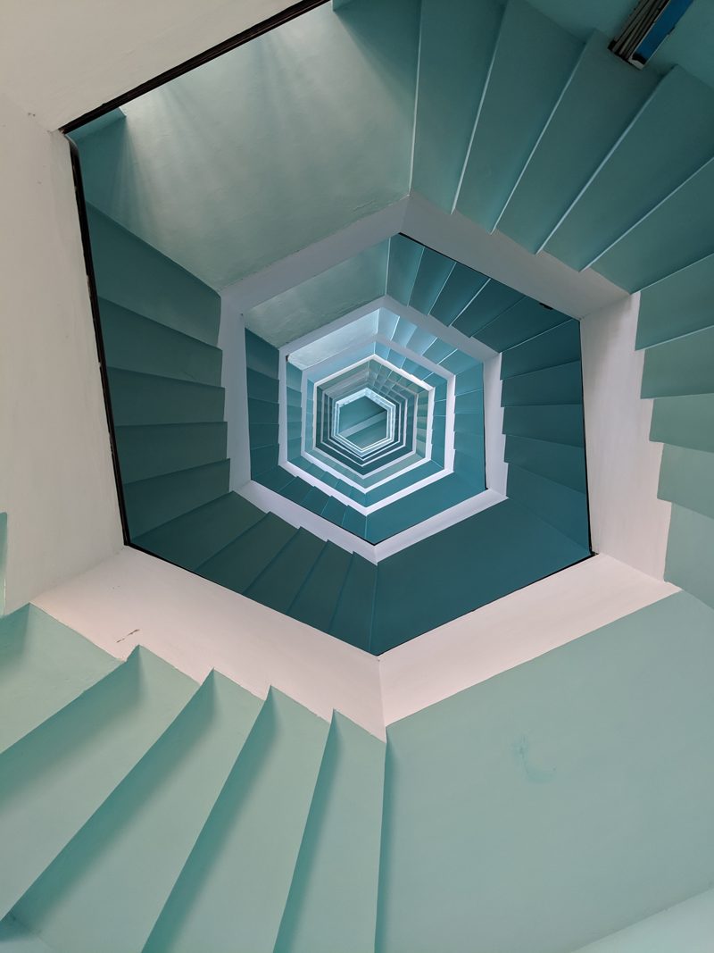 infinite swirling staircase in ocean blue, hexagon shaped, center view